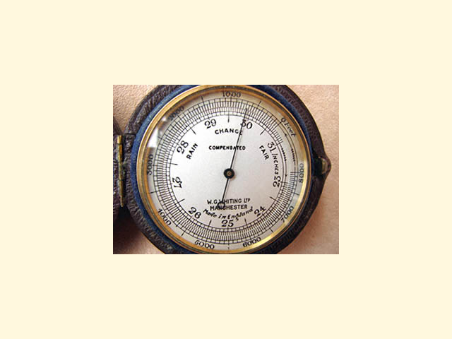 Close up view of barometer dial with altimeter scale to 8000 feet.